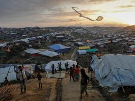 Rohingya refugee children fly improvised kites at the Kutupalong refugee camp near Cox's Bazar