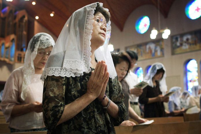 BI_Catholics praying for atomic bomb victims during a Mass