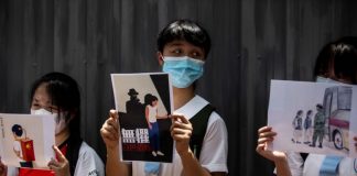 BI_School students hold signs during a pro-democracy protests