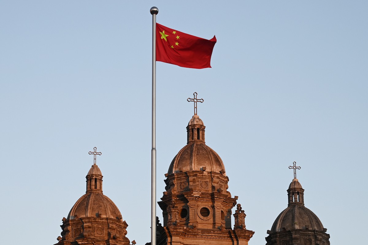 The Chinese national flag flies in front of St. Joseph's Church