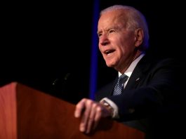 Joe Biden speaking from behind a lectern