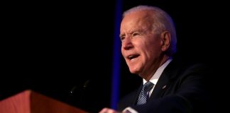 Joe Biden speaking from behind a lectern