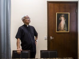 Cardinal Joseph Zen leaning on a chair