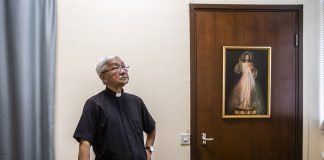 Cardinal Joseph Zen leaning on a chair