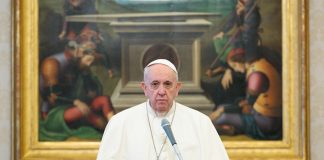 Pope Francis in front of large painting