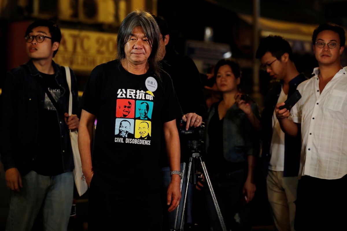 Leung Kwok-hung stands outside a counting center