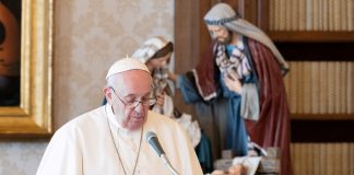 Pope Francis giving address behind lectern