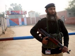 A Pakistani policeman stands guard outside