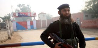A Pakistani policeman stands guard outside