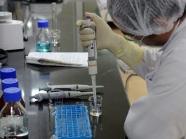 A research scientist works inside a laboratory in Pune