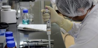 A research scientist works inside a laboratory in Pune