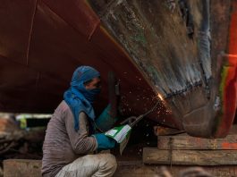 Worker breaking up a ship in Dhaka