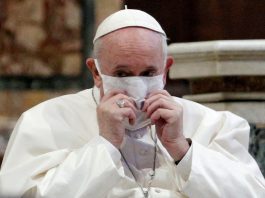 Pope Francis wearing a white mask