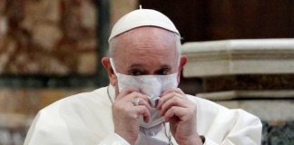 Pope Francis wearing a white mask