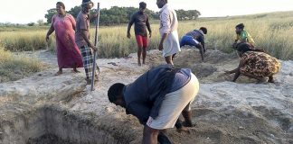 Local residents in Sri Lanka try to fill the graves dug by the authorities to bury COVID-19 victims