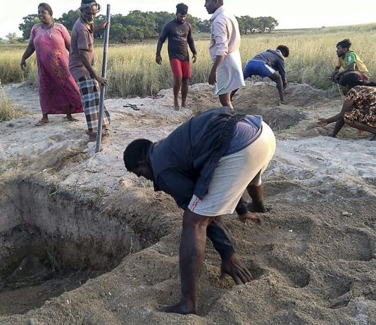 Local residents in Sri Lanka try to fill the graves dug by the authorities to bury COVID-19 victims