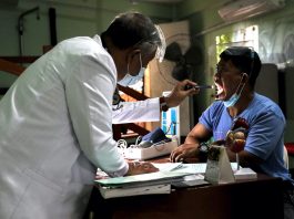 Doctor using a flash light to examine a patient