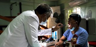 Doctor using a flash light to examine a patient