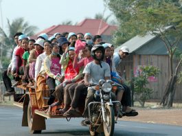 Garment workers on overloaded motor-rickshaw