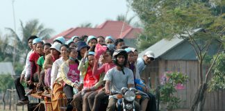 Garment workers on overloaded motor-rickshaw