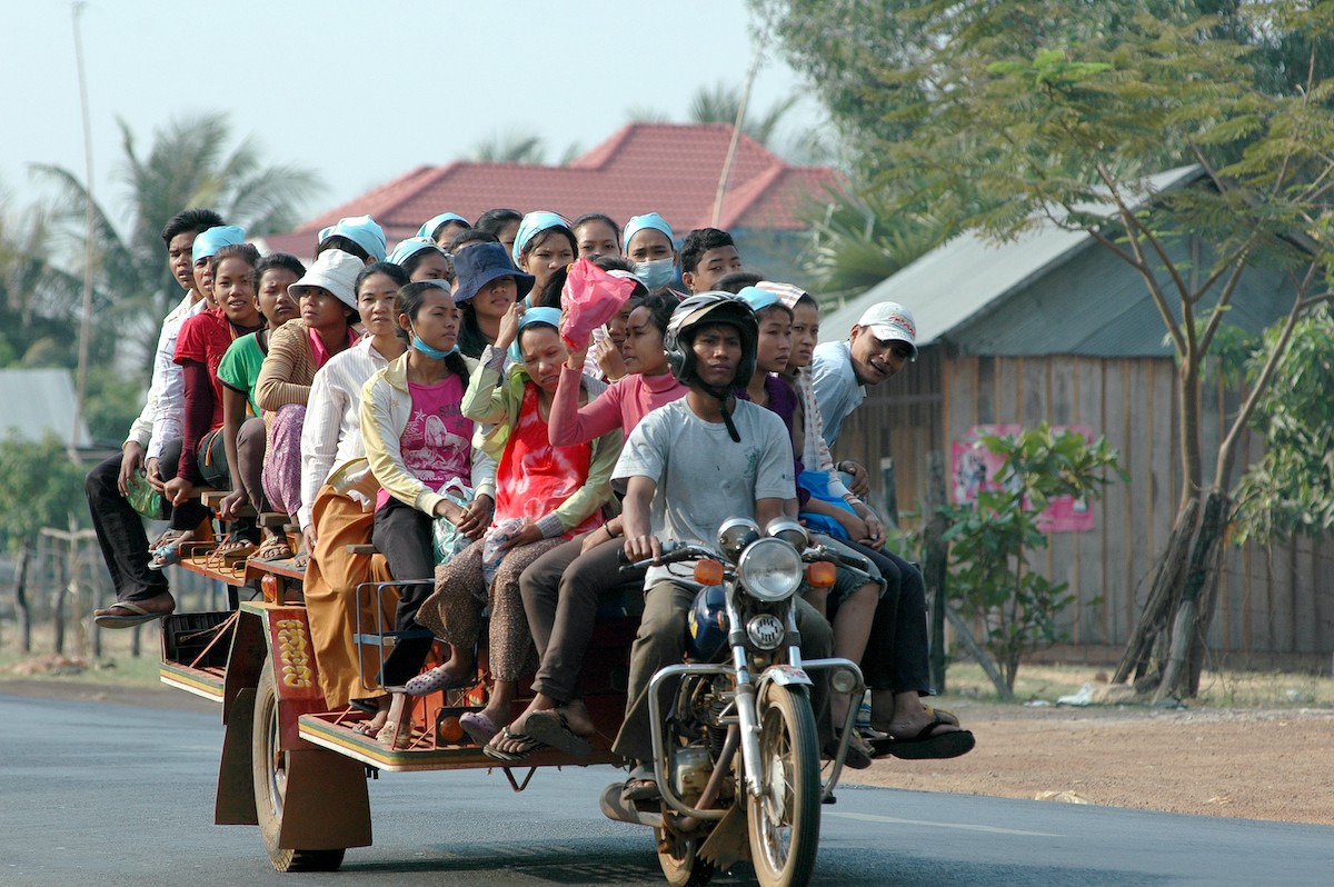 Garment workers on overloaded motor-rickshaw