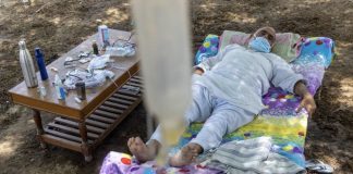 Indian man lying under a Neem Tree