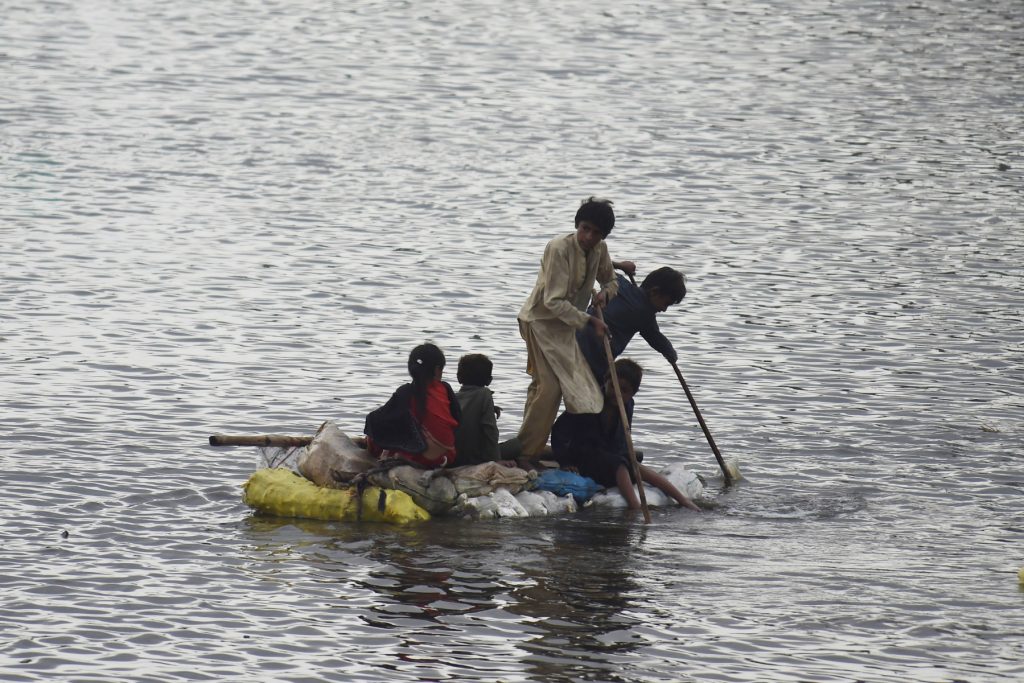 Children on raft in Pakistan flood