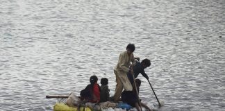 Children on raft in Pakistan flood