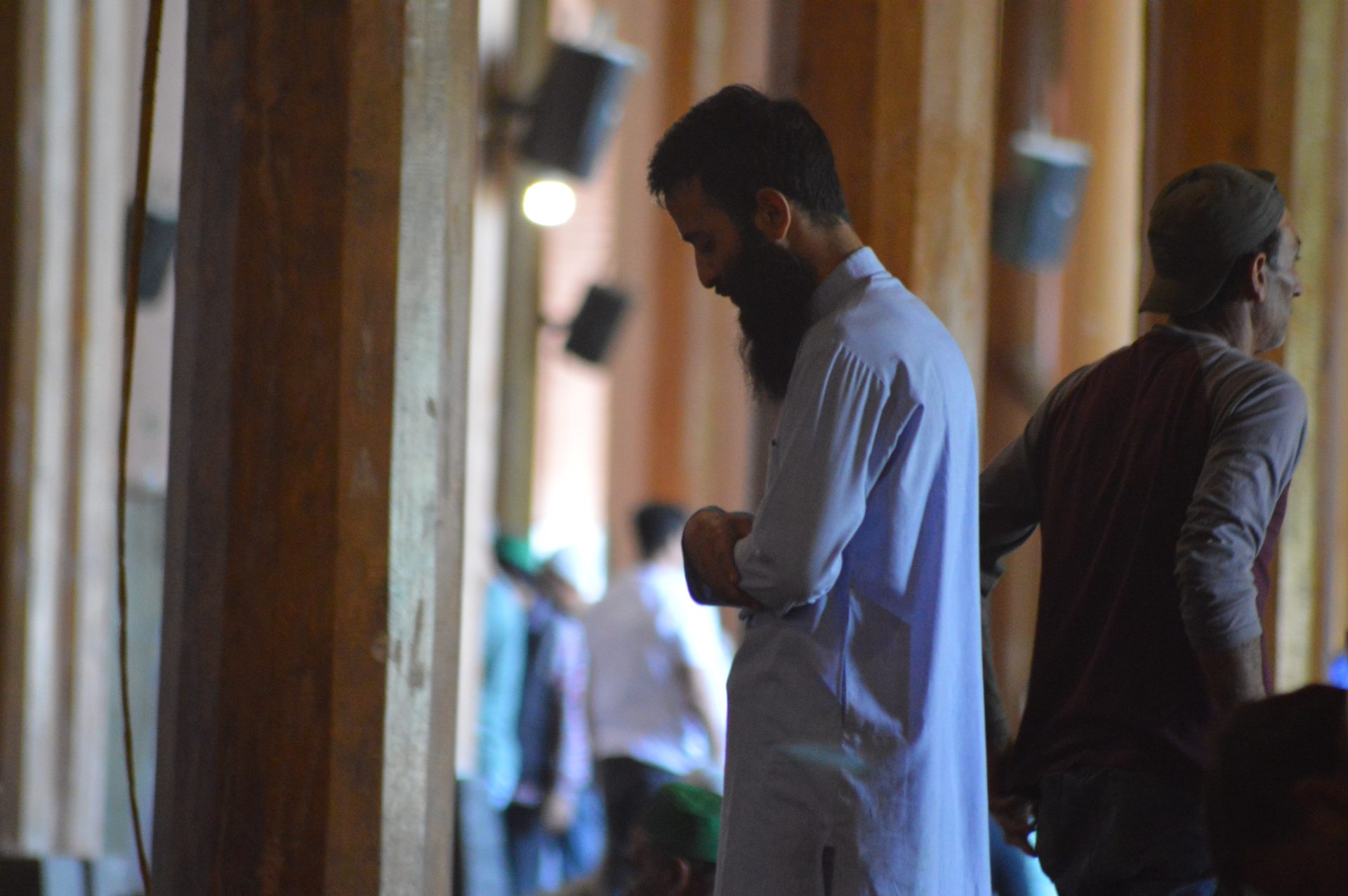 A muslim man praying in a mosque (side profile)
