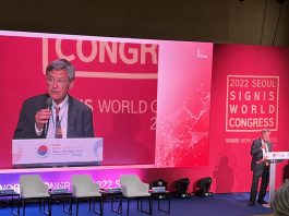 Dr. Paolo Ruffini, Prefect of the Dicastry for Communication, standing on stage delivering a speech