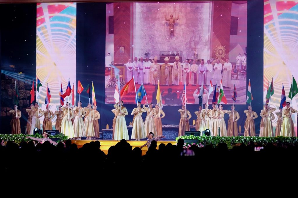 Thai youth holding flags on large stage FABC50