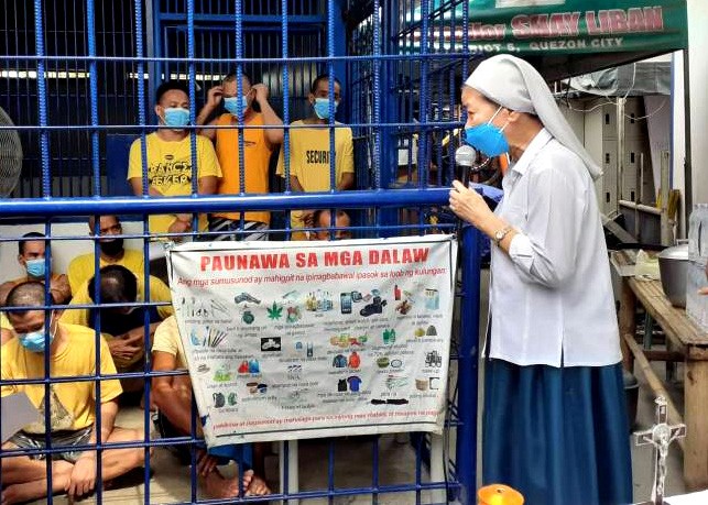 A nun talking to prisoners in the Philippines