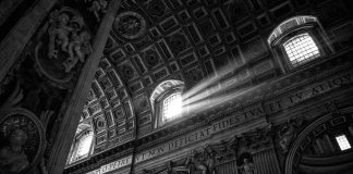 Black and white photo of interior of St. Peter's Basilica, Vatican City.