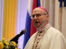 Archbishop Peter Bryan Wells speaking from a lectern