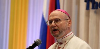 Archbishop Peter Bryan Wells speaking from a lectern