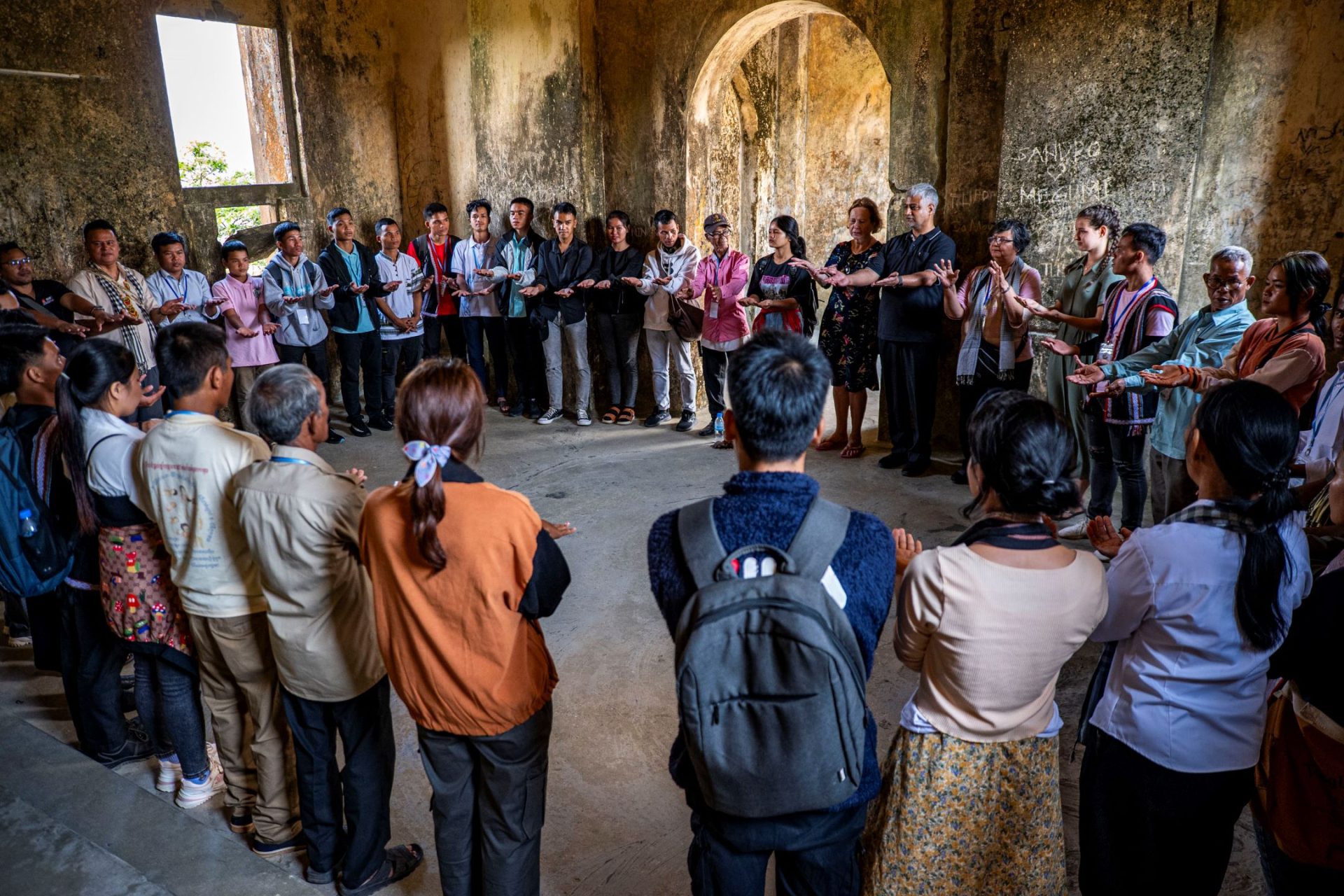 Indigenous groups of Cambodia standing in a circle in casual clothings.