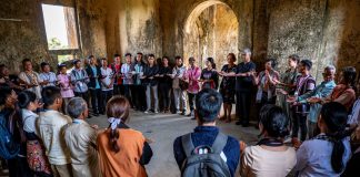 Indigenous groups of Cambodia standing in a circle in casual clothings.