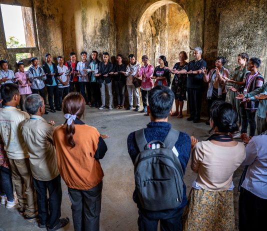 Indigenous groups of Cambodia standing in a circle in casual clothings.