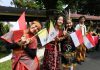 Children waving Vatican and Indonesian flags