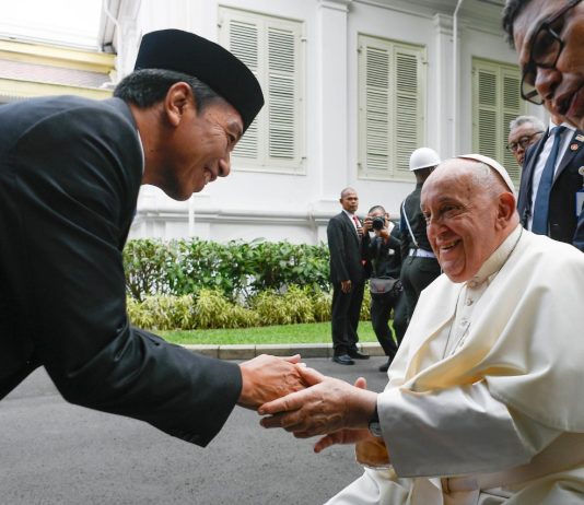 Pope Francis shakes hand President Joko Widodo of Indonesia