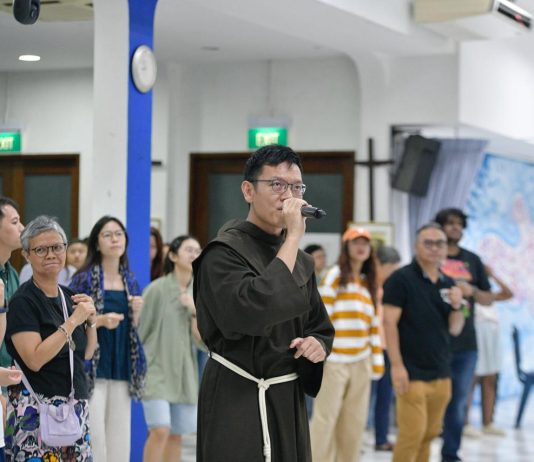 Friar Derrick Yap performs at rehearsal for the Papal Mass