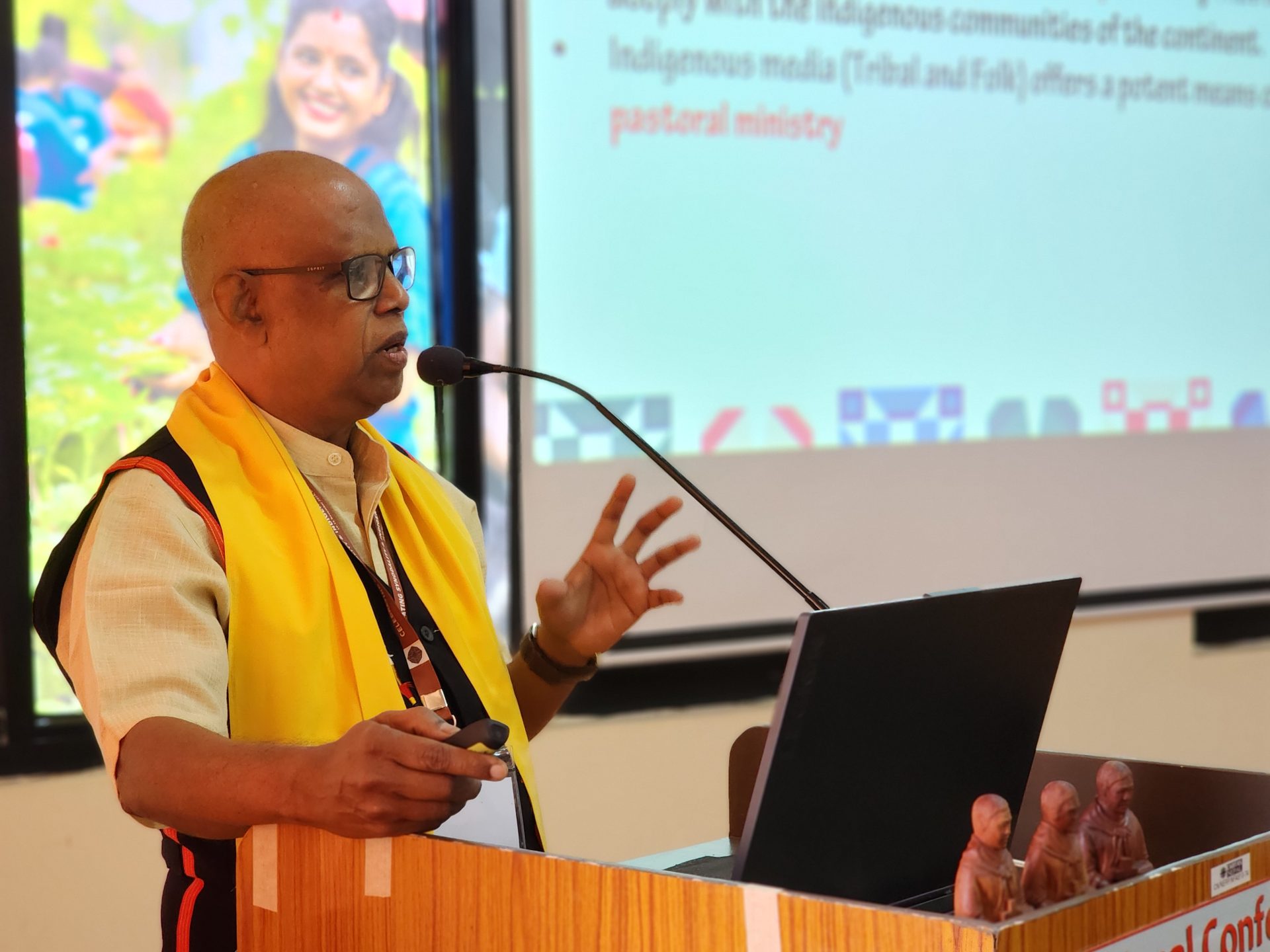Fr. Vincent Wilson speaking at a podium in Nepal