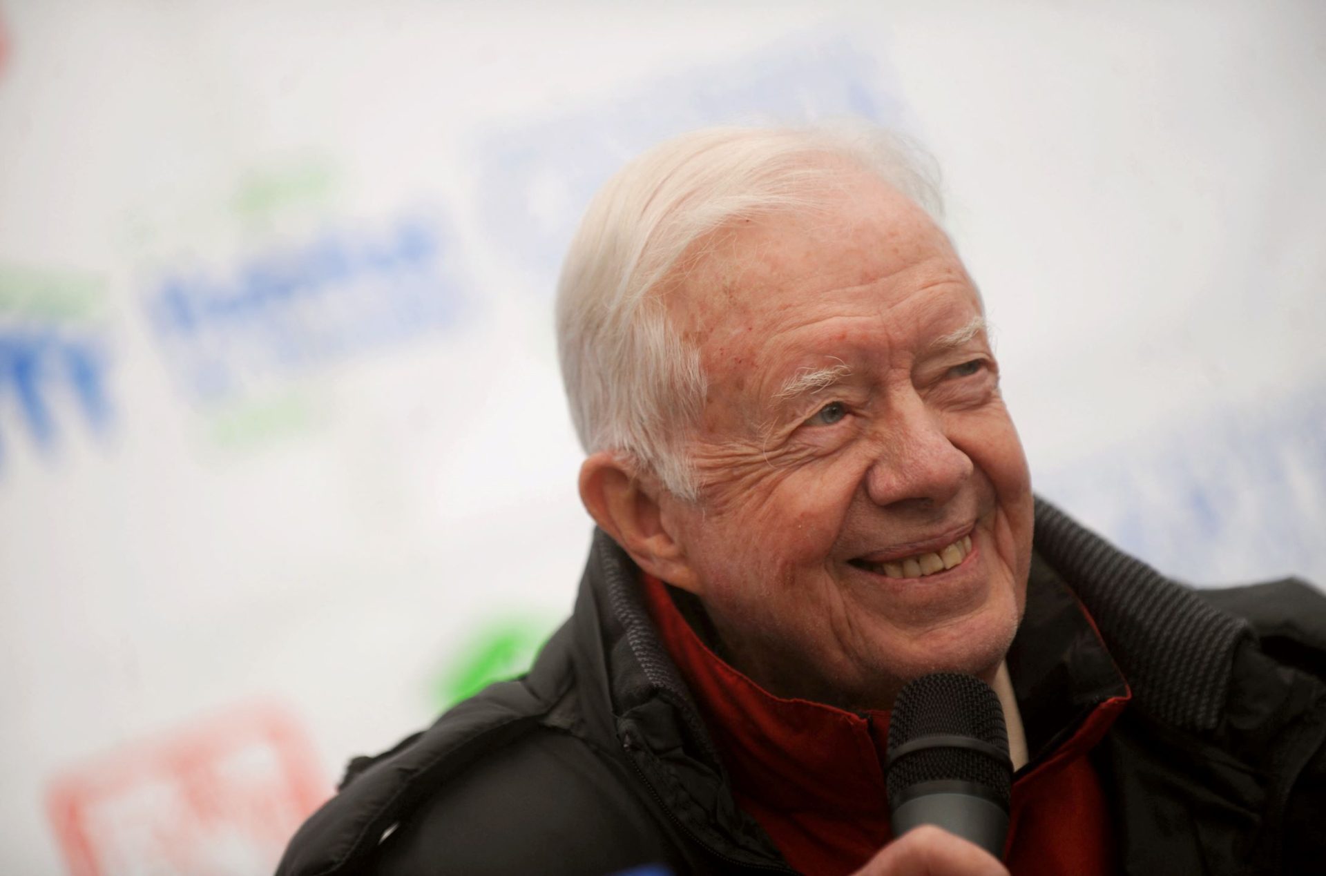 Former US president Jimmy Carte smiling on a blurred background