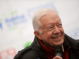 Former US president Jimmy Carte smiling on a blurred background