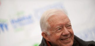 Former US president Jimmy Carte smiling on a blurred background