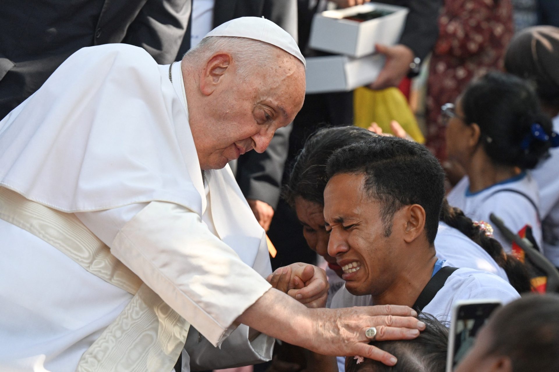 Pope Francis blessing a child in Dili