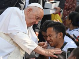 Pope Francis blessing a child in Dili