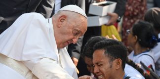 Pope Francis blessing a child in Dili