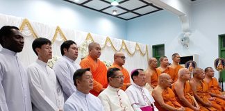 A group of Catholic clergy and Buddhist monks sitting together.