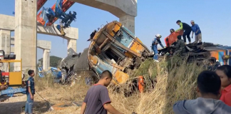 Derailed train carriages after a crane collapsed onto a passenger train (Thailand)